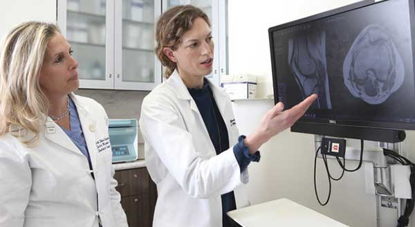 women's sports doctors examine scans