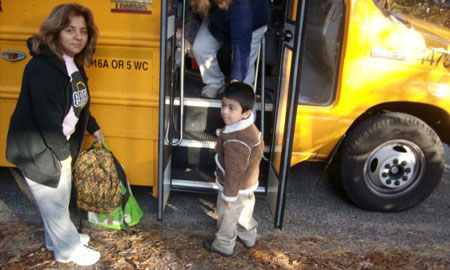 Photo of Ismael Vega and his mom as Ismael boards the bus