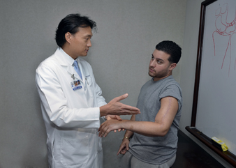 Photo of Dr. Steven K. Lee examining a patient