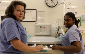 Nurses Elizabeth Goetz and Tashma Watson confer outside the inpatient OR suite at Hospital for Special Surgery.