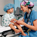 A nurse examining a small child