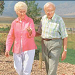 Photo of a senior couple walking in a field