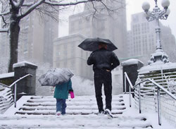 Photo of a parent and child walking on a snowy day.