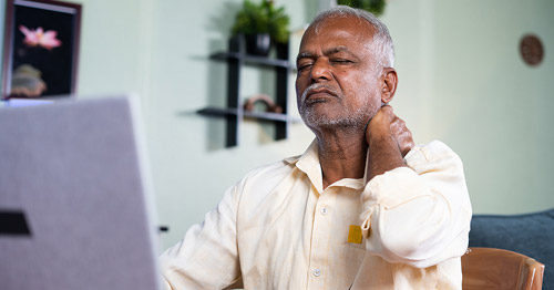 A man holding his neck in pain.