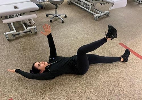 woman demonstrating dying bug exercise