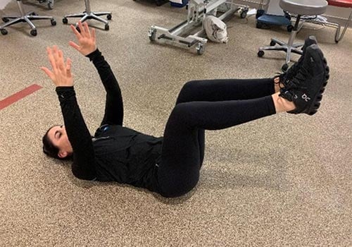 woman demonstrating dying bug exercise