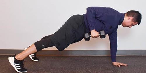 man doing plank rows