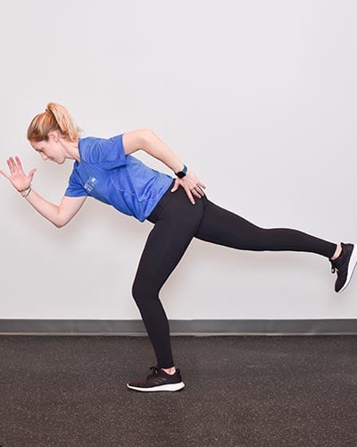 woman demonstrating running man single leg deadlift
