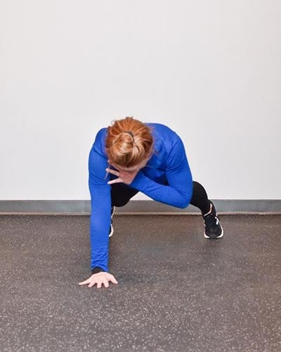 woman performing shoulder tap exercise