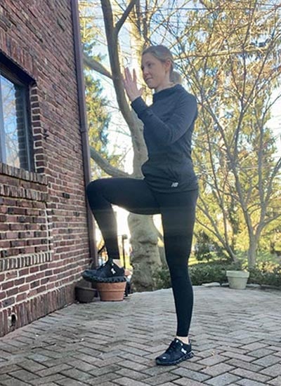 woman demonstrating standing marches exercise