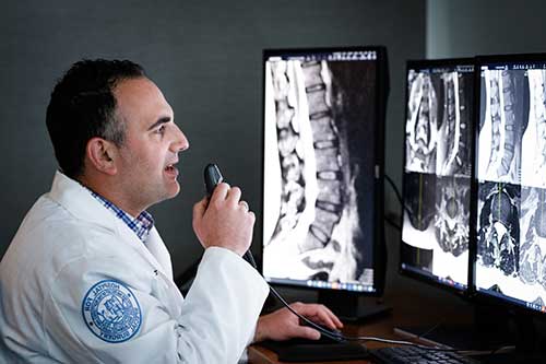 radiologist looks at spine x-rays