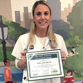 Photo of Ashley Laird holding her DAISY Award.