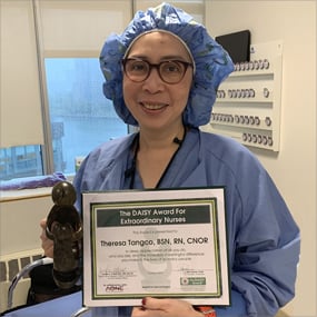 Photo of Theresa Tangco holding her DAISY Award