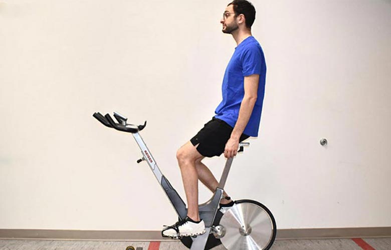 man on exercise bike demonstrating seat distance