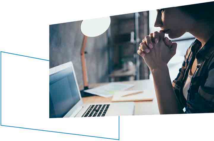 A woman on a remote meeting at her laptop.