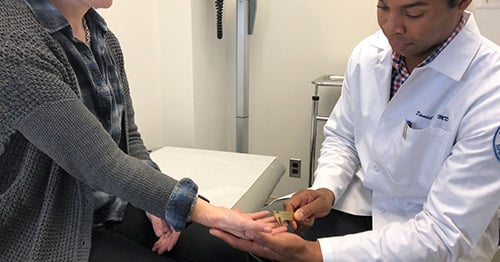 nappy.co/photo/2349 licesnse-free Dr. Osei examining a patient.