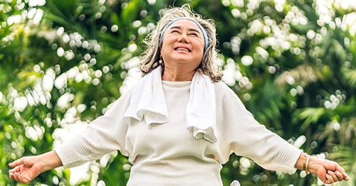 An older woman, happy she is relieved of back pain.