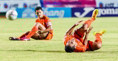 A professional footballer soccer player with a knee injury.