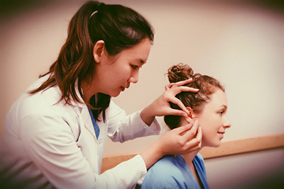 Dr. Stephanie Cheng performs acupuncture on a patient.