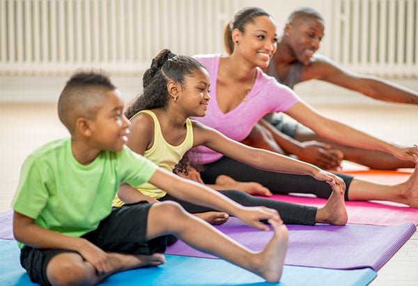 Parents and children stretching on yoga mats