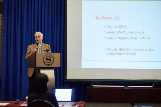 Dr. Michael Lockshin presenting at an event.
