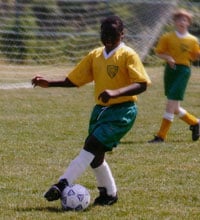 Photo of Lansana playing soccer