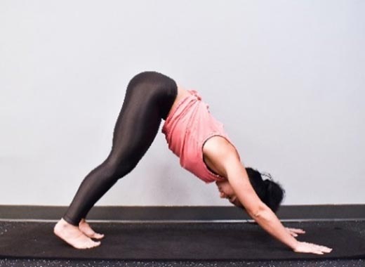 photo of cara demonstrating Downward-facing dog stretch
