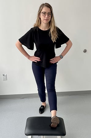Image of a woman with her right leg on a stool