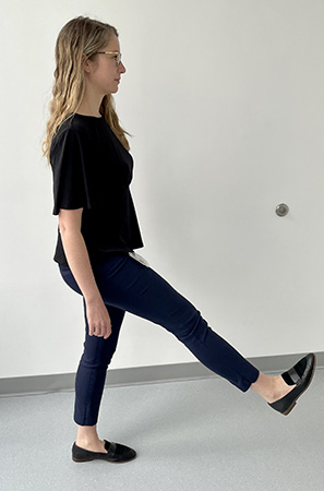 Image of a woman swinging her right leg foward