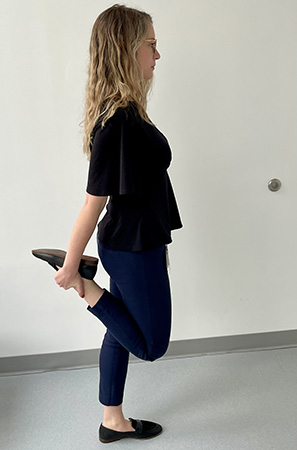 Image of a woman stretching her right quadriceps