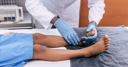 A doctor examing a child's foot.